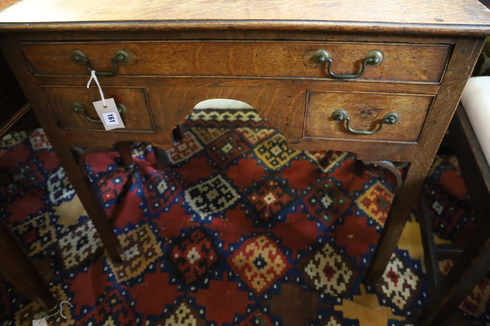 A George III oak low boy, with one long and two short drawers, with brass drop handles, on square section supports, width 79cm, depth 4